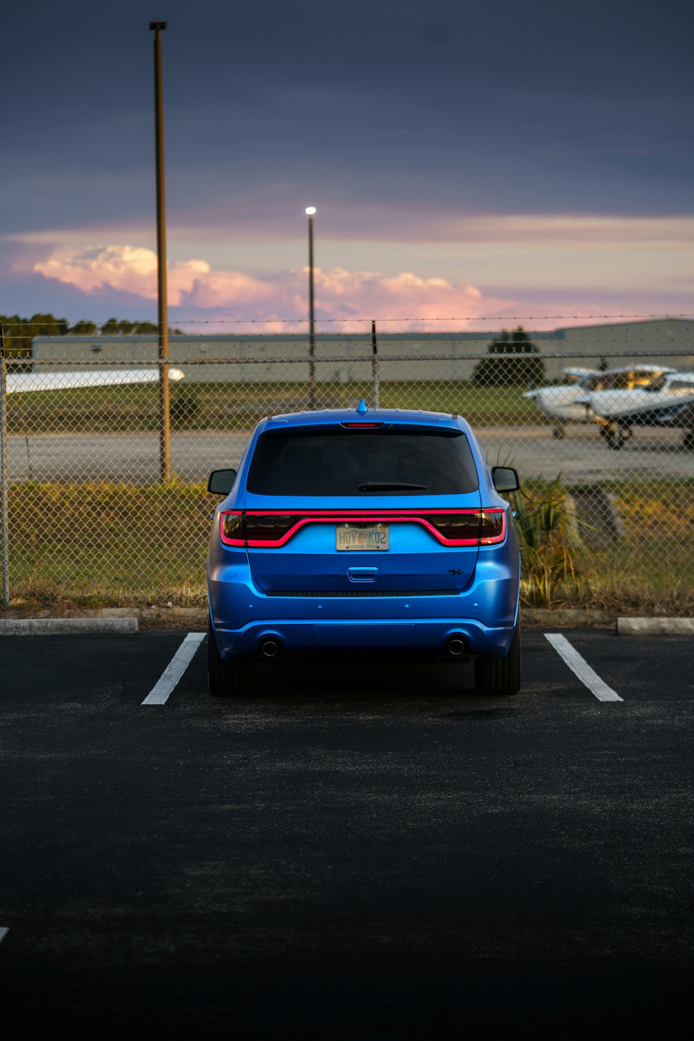 a blue car parked in a parking lot