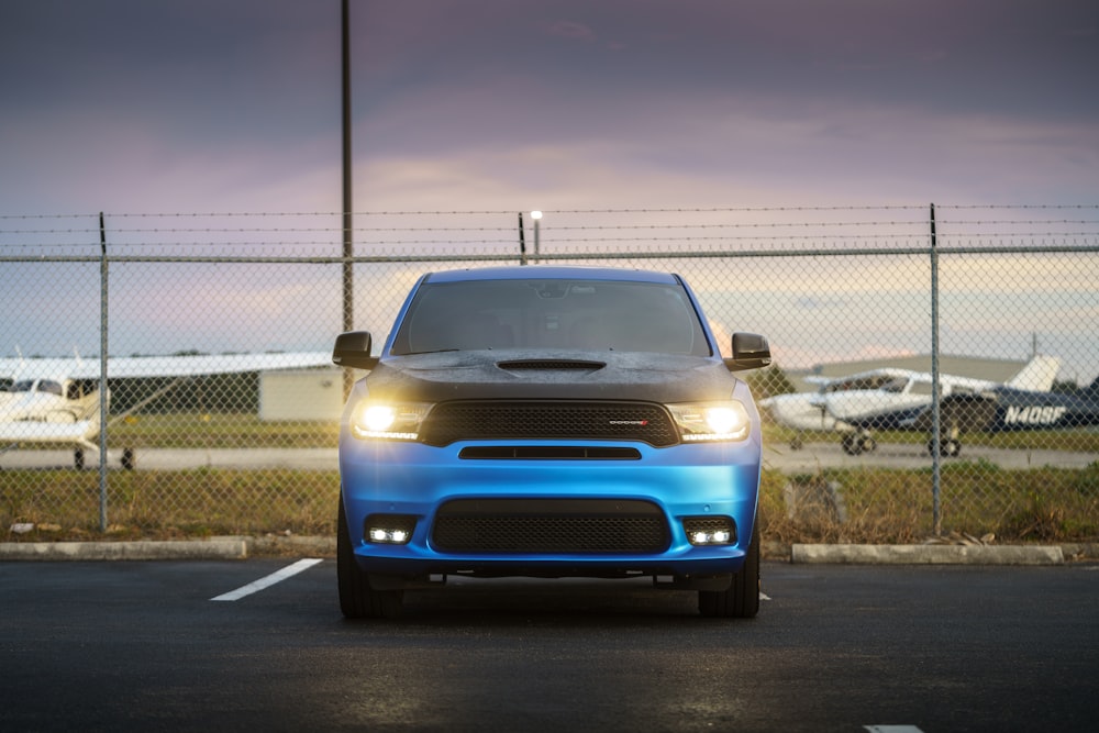 a blue dodge truck parked in a parking lot