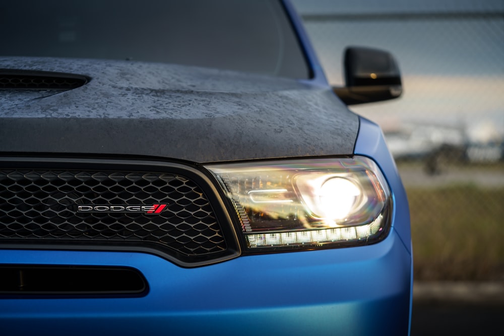 a close up of the front of a blue truck