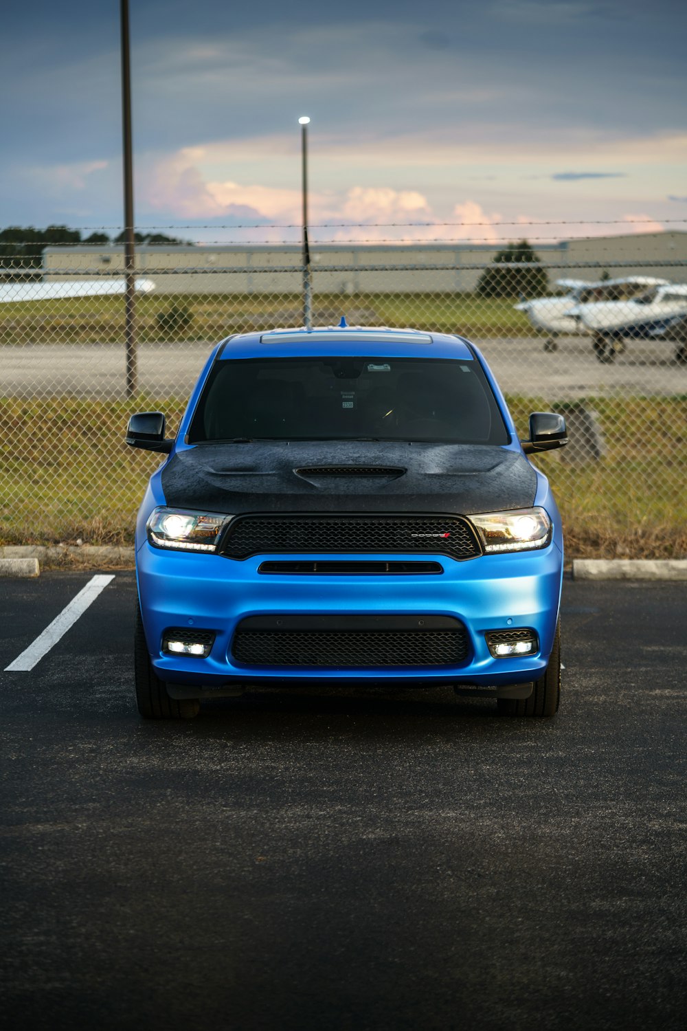 a blue dodge truck parked in a parking lot