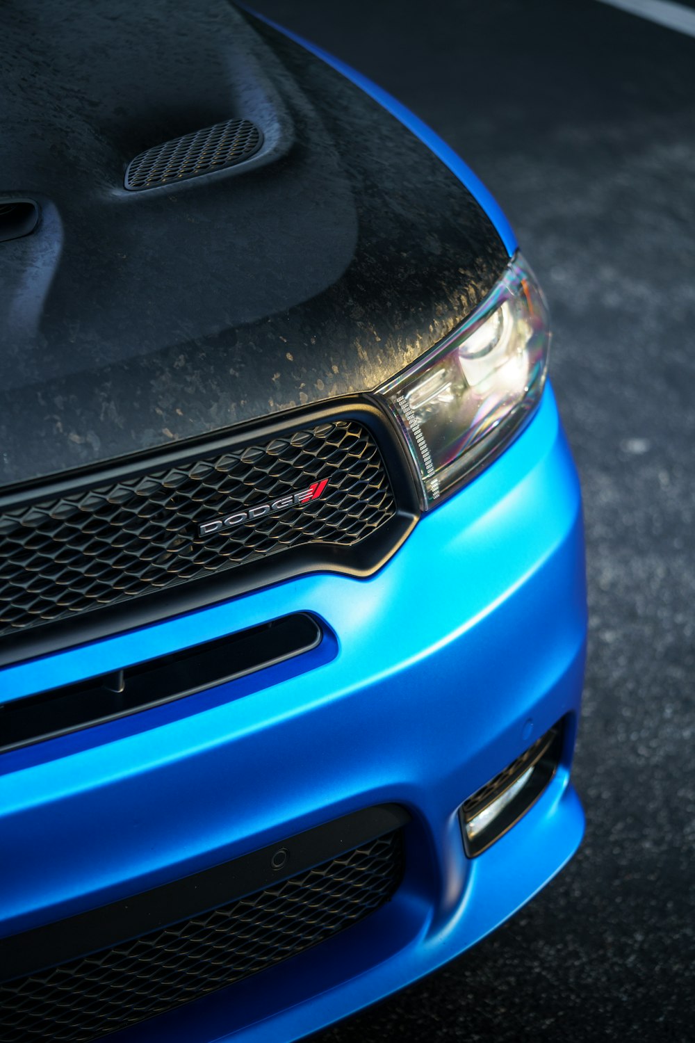 a close up of the front of a blue car