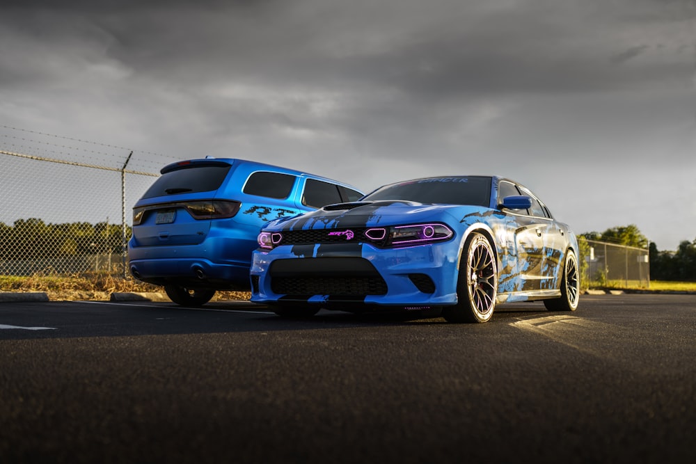 a couple of cars parked next to each other on a road