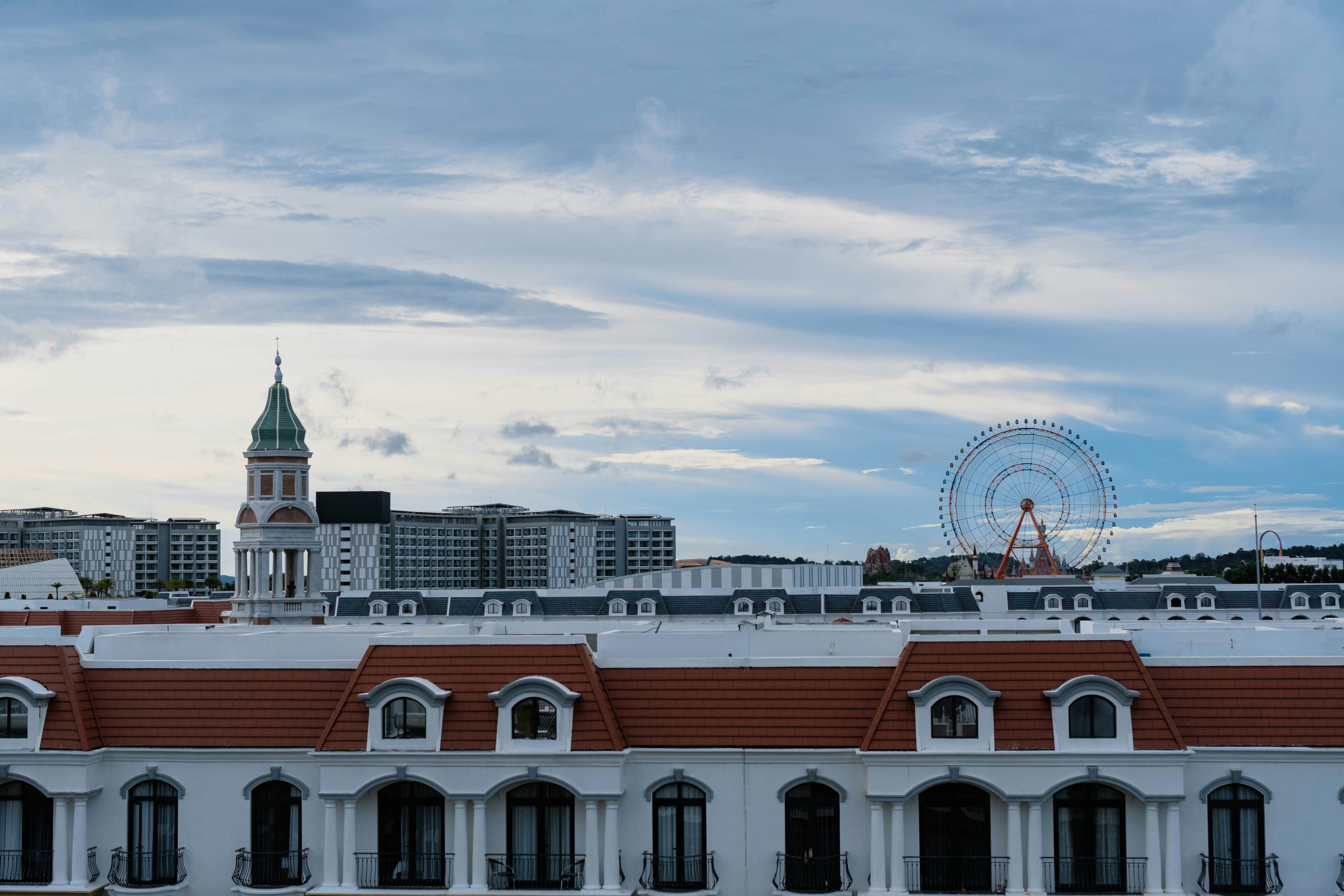a view of a building with a ferris wheel in the background
