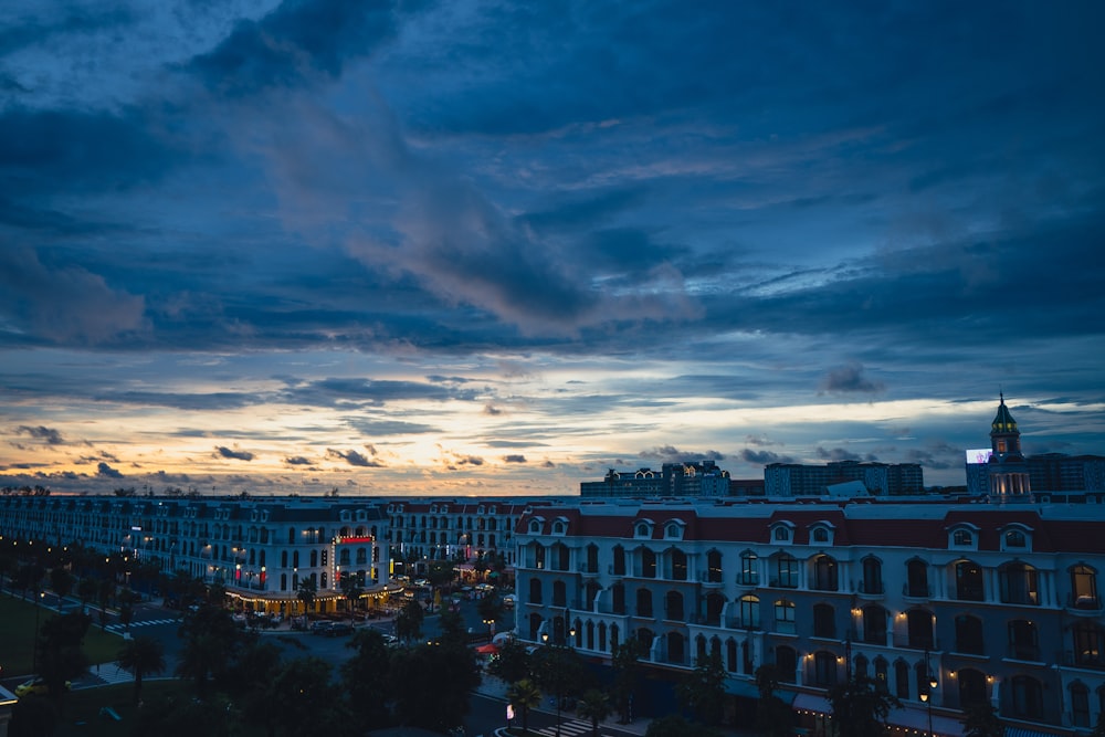 a view of a city at night with clouds in the sky