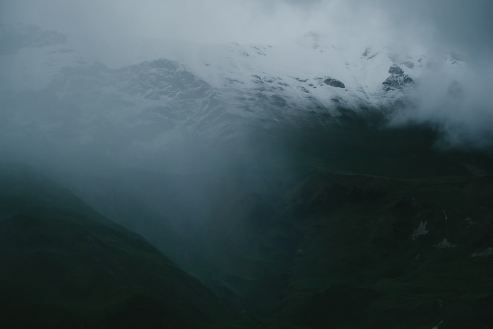 a view of a mountain covered in clouds