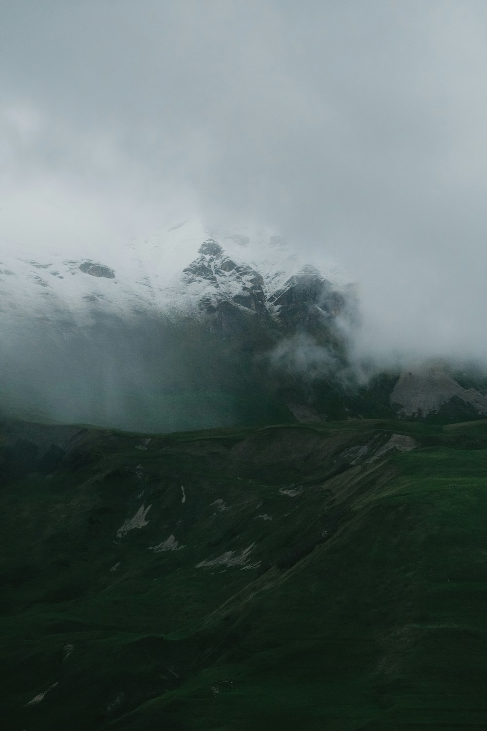 a view of a mountain range with clouds in the sky