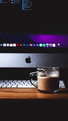 a cup of coffee sitting on top of a wooden table