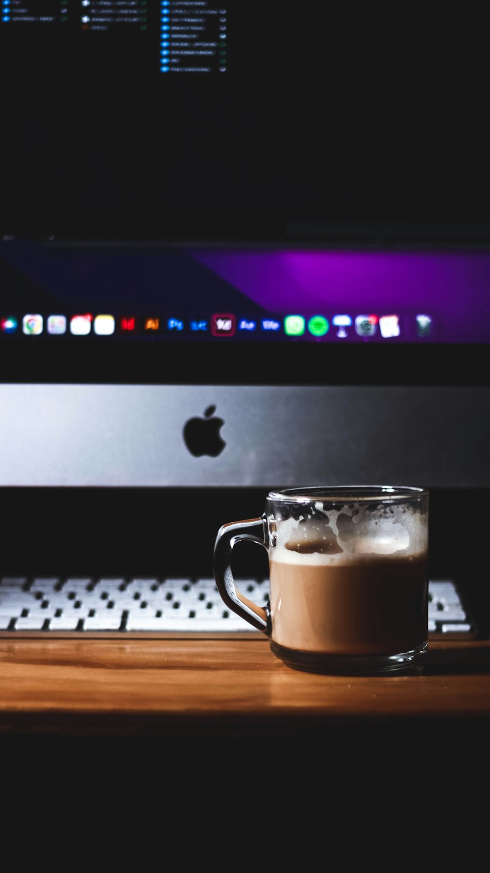 a cup of coffee sitting on top of a wooden table