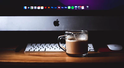 a cup of coffee sitting on top of a wooden table