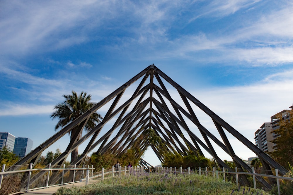 a wooden structure in the middle of a field