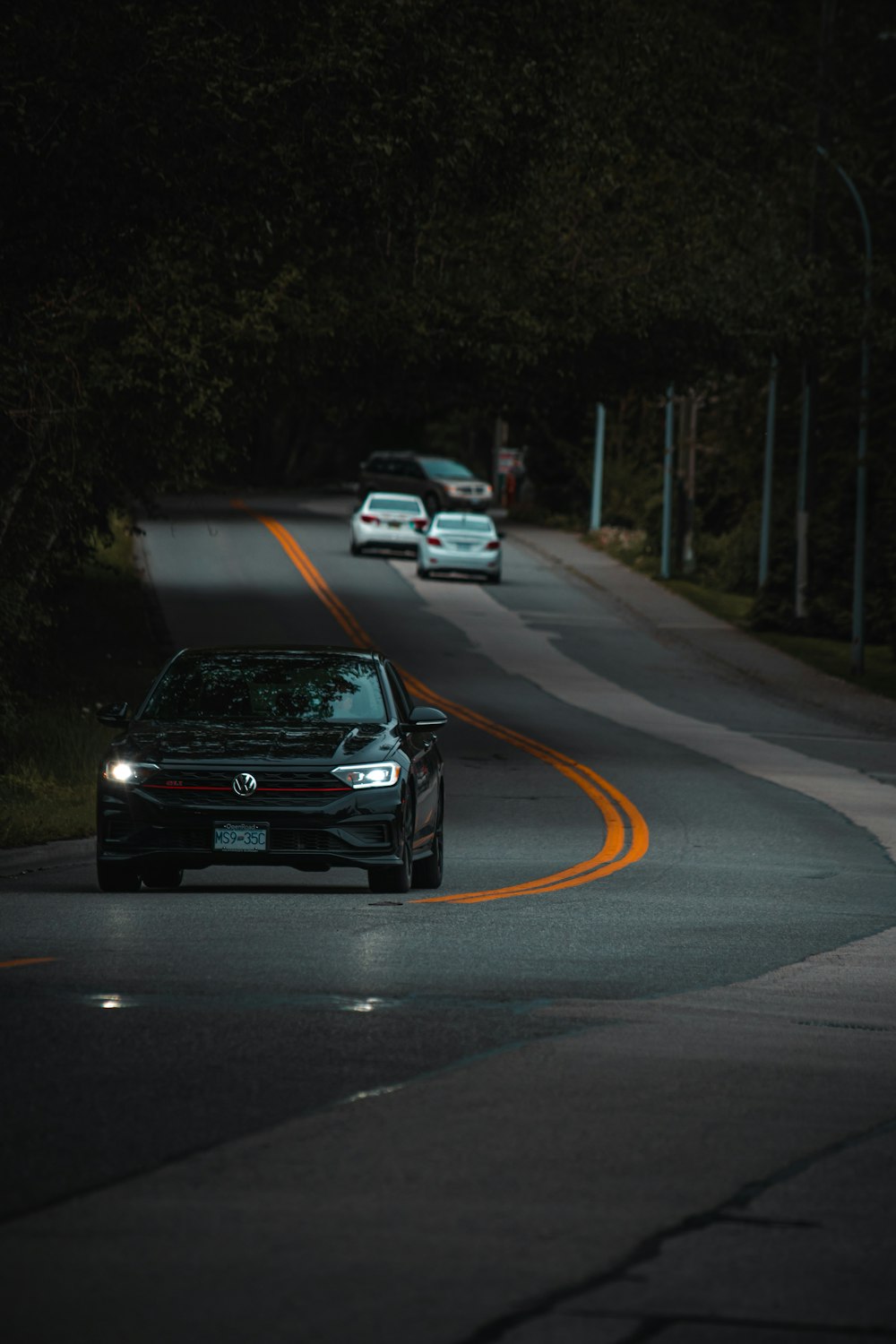 a car driving down a street at night