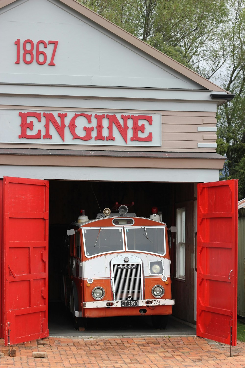 an old fire truck is parked in a garage