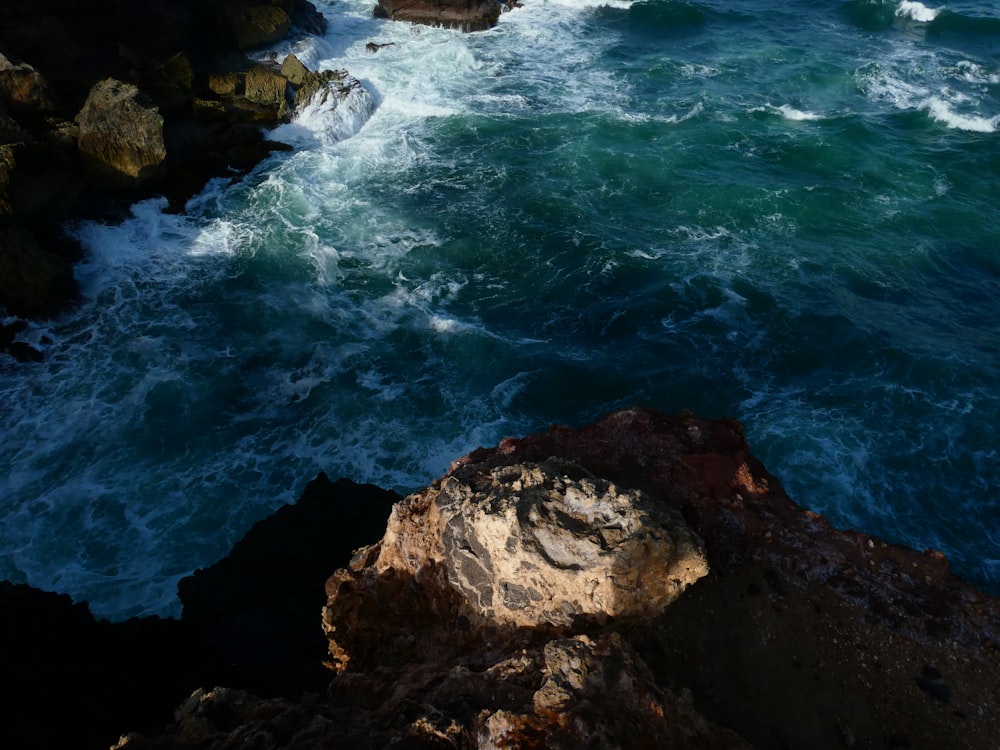 a rocky cliff overlooks a body of water