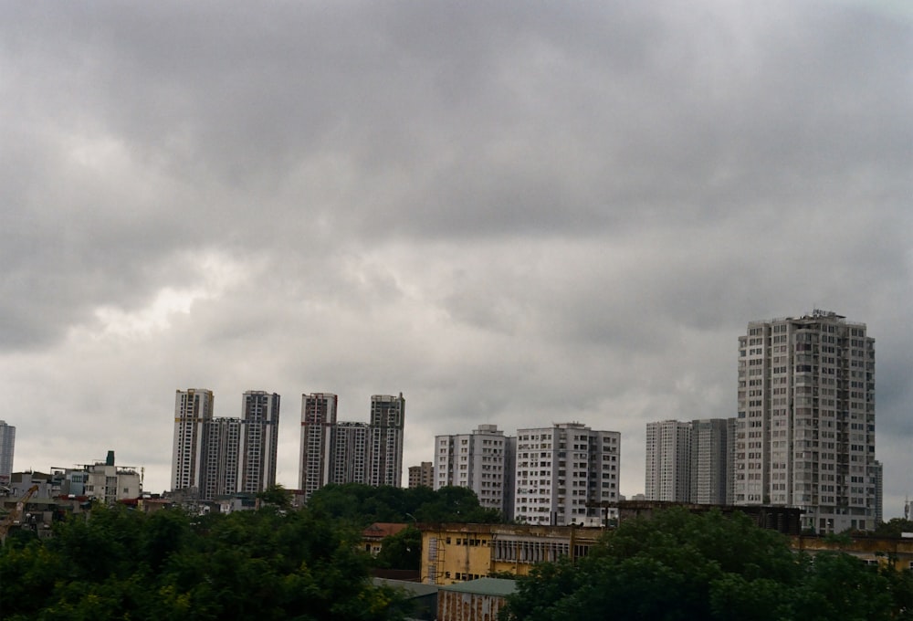 a cloudy sky over a city with tall buildings