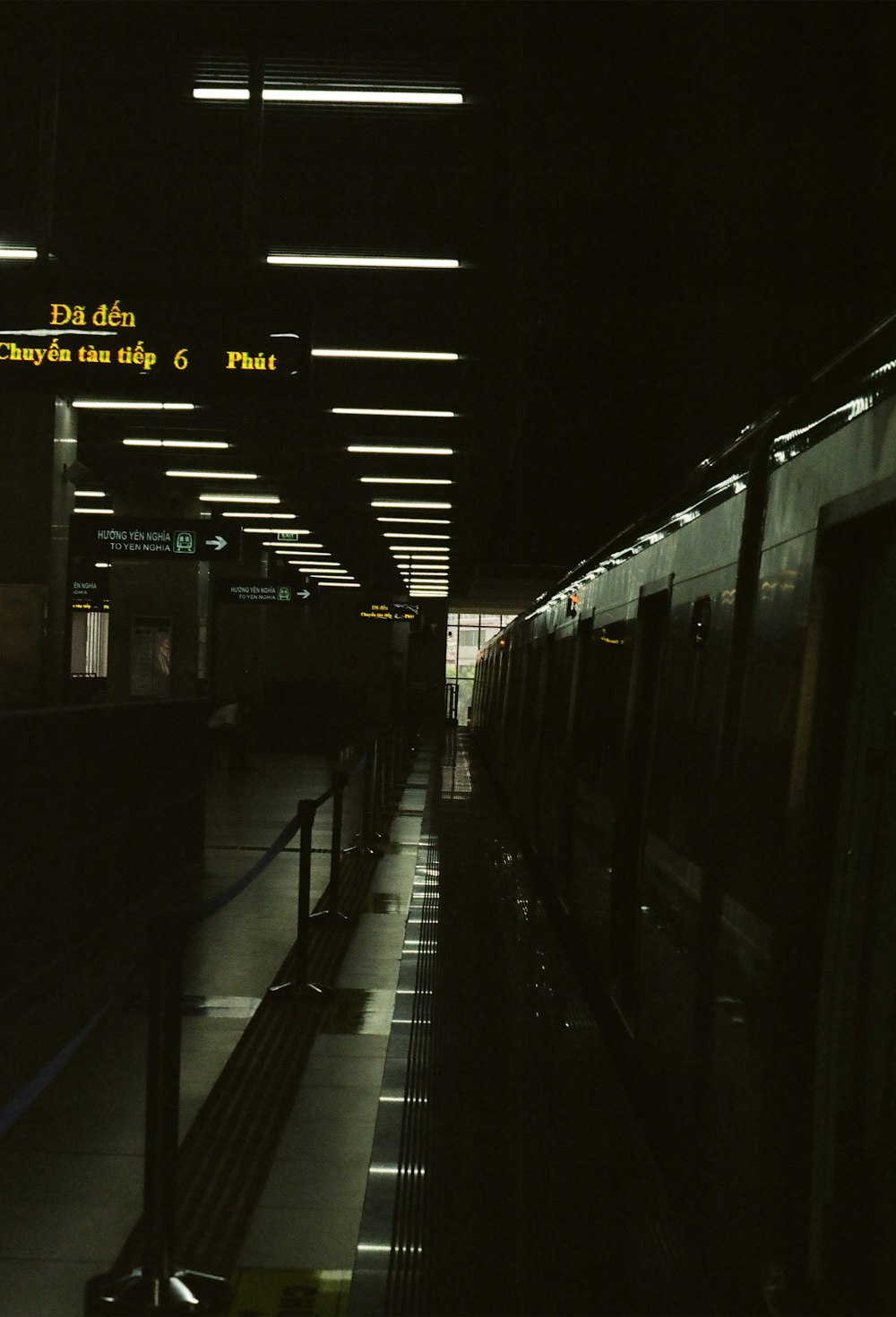 a train is parked at a train station at night