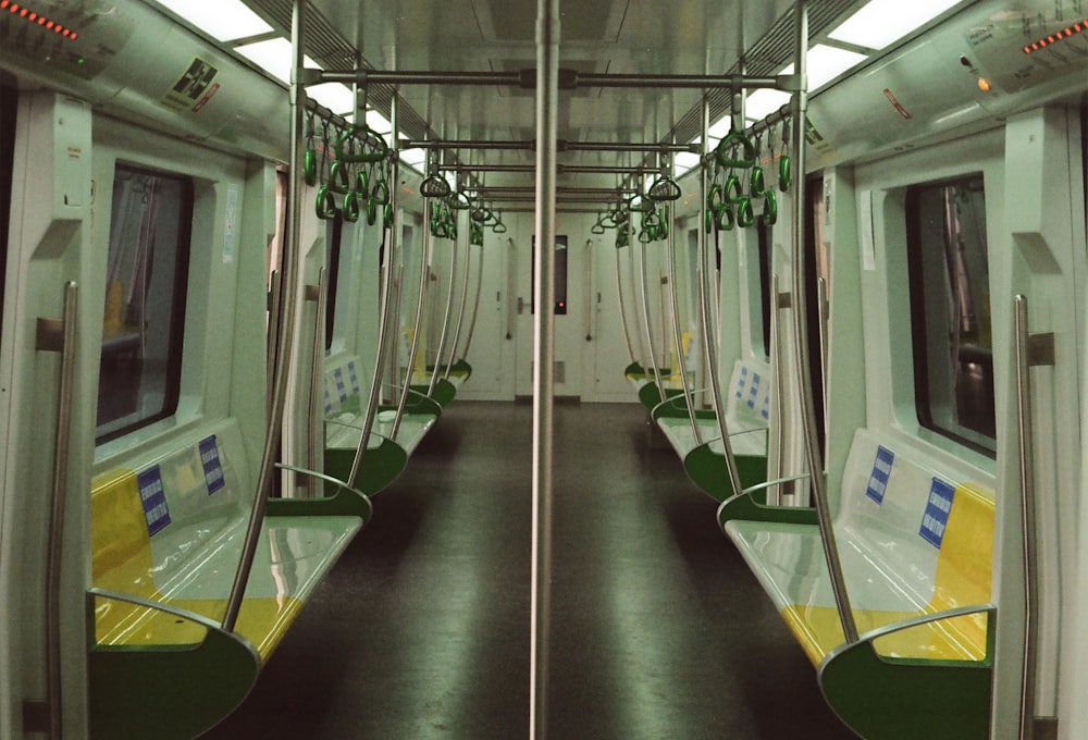 a subway car with green and yellow seats