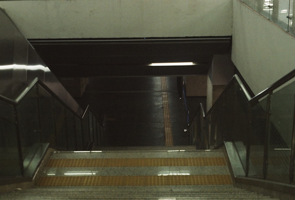 an escalator leading up to a subway station