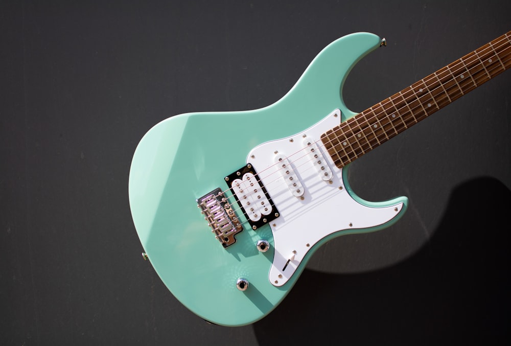 an electric guitar with a light green body