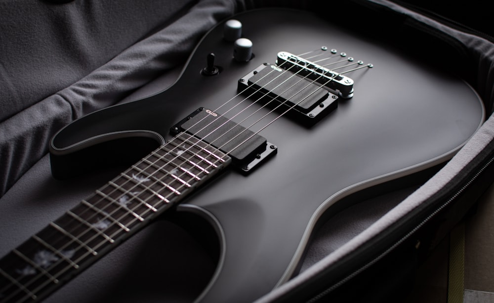 a black electric guitar in a case