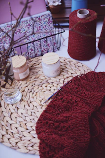 a close up of a table with yarn and scissors