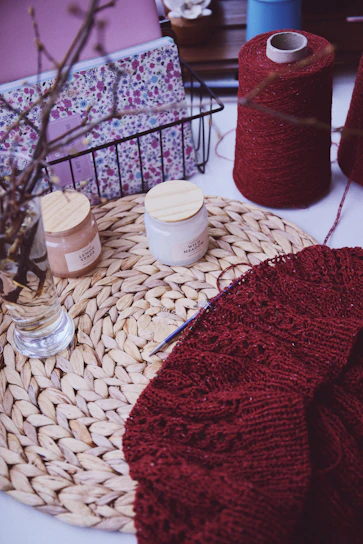 a close up of a table with yarn and scissors
