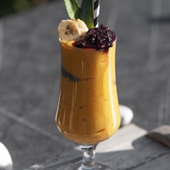 a smoothie with bananas and cranberry in a glass