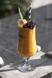 A vibrant smoothie card showcasing the Knockout smoothie with bananas, strawberries, and a hint of peanut butter on a dark background accented with fuchsia pink