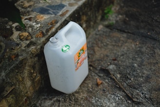 a gallon of milk sitting on the ground