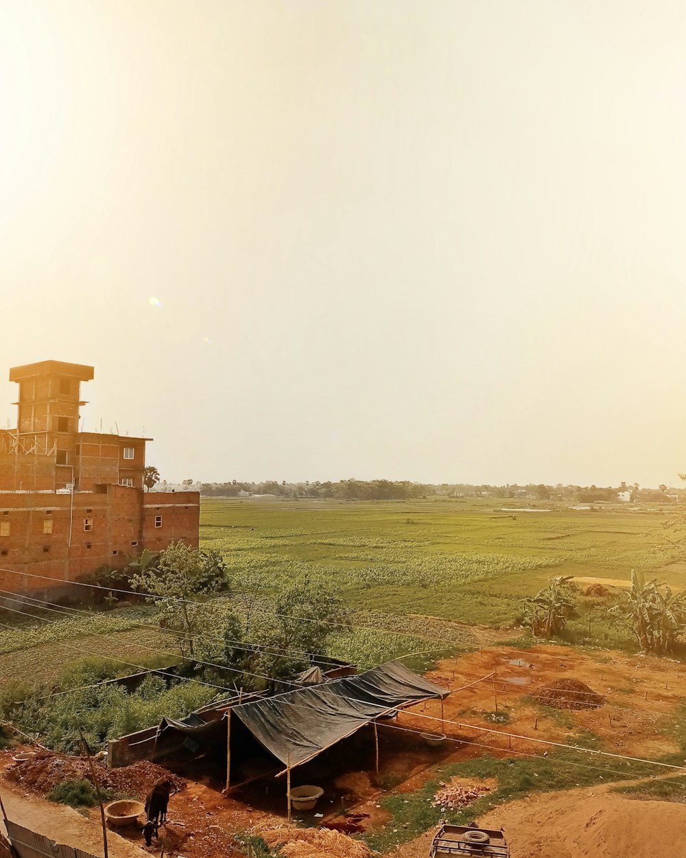 a field with a building in the background