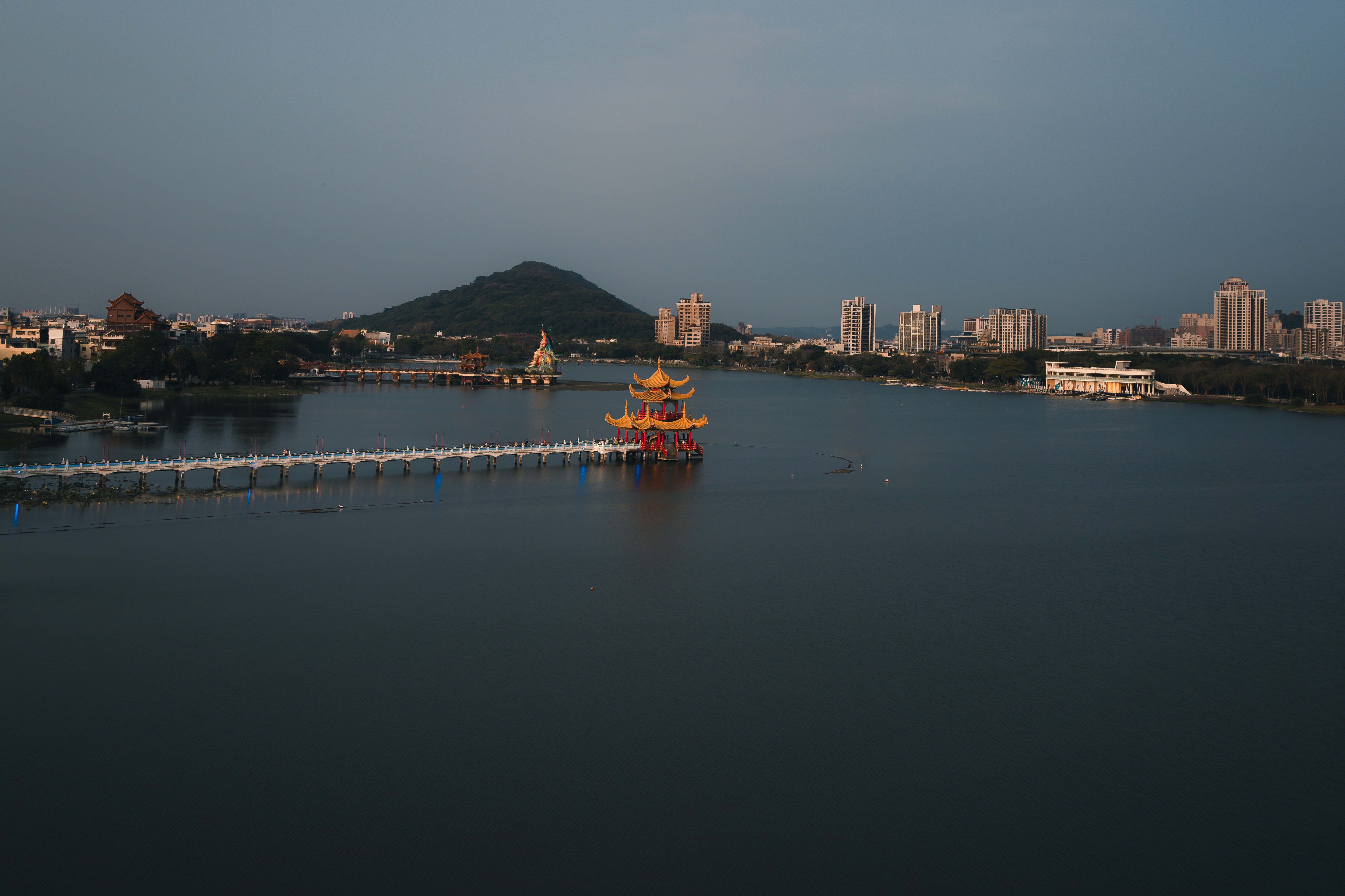 Large body of water surrounded by tall buildings at dawn. Photo by Anledry Cobos on Unsplash.
