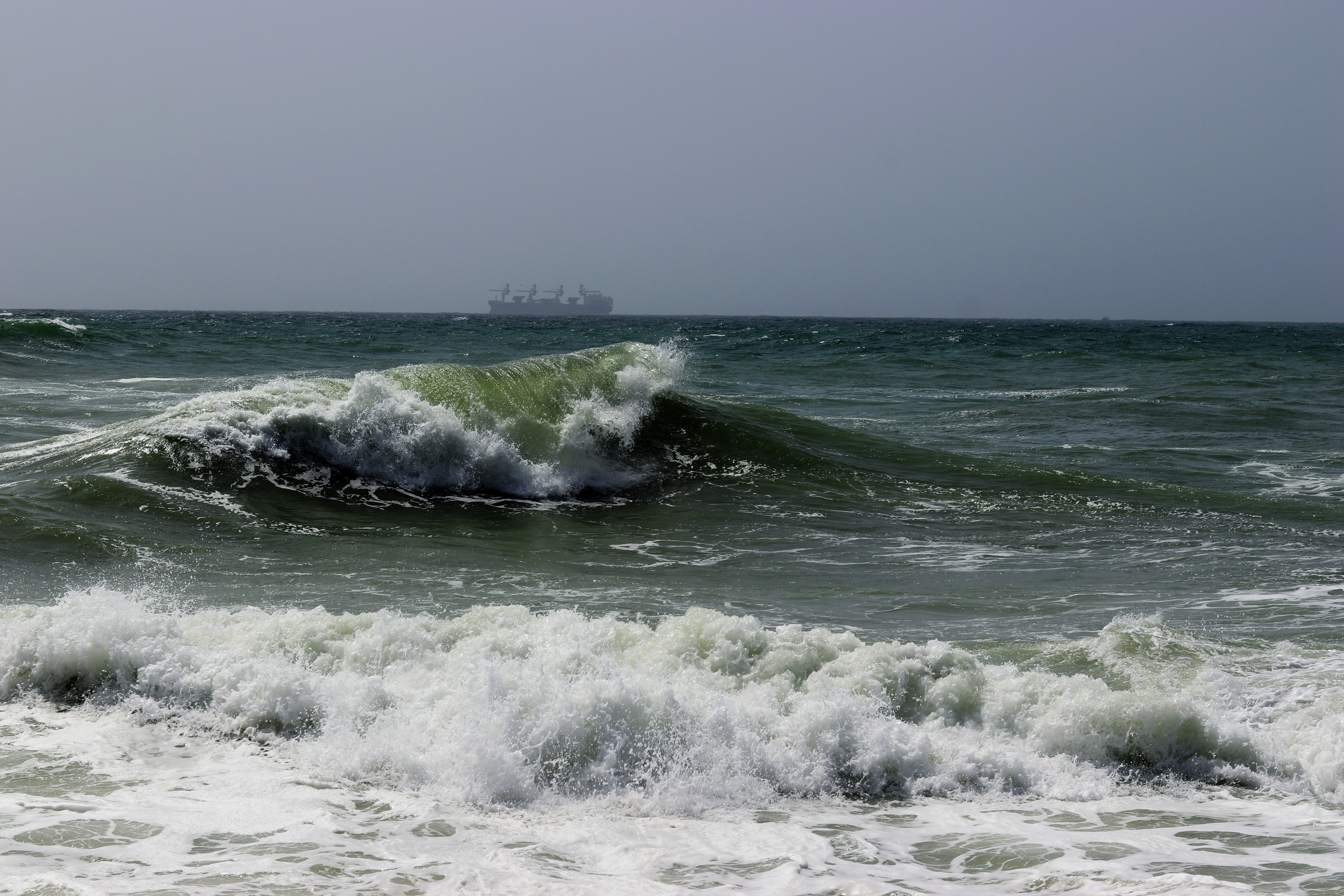 a large body of water with a ship in the distance