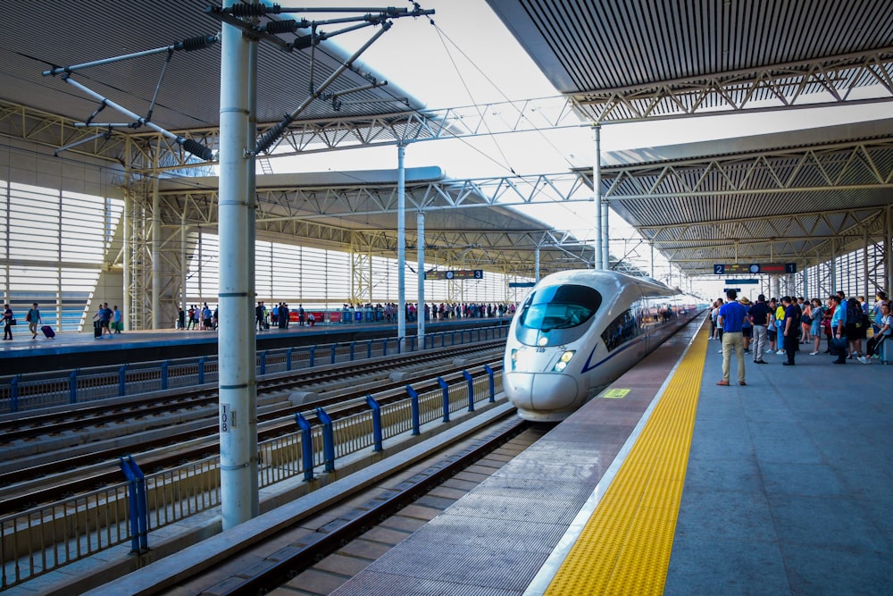 a bullet train pulling into a train station