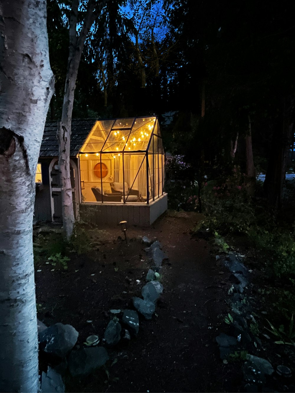 a small house with lights on in the dark