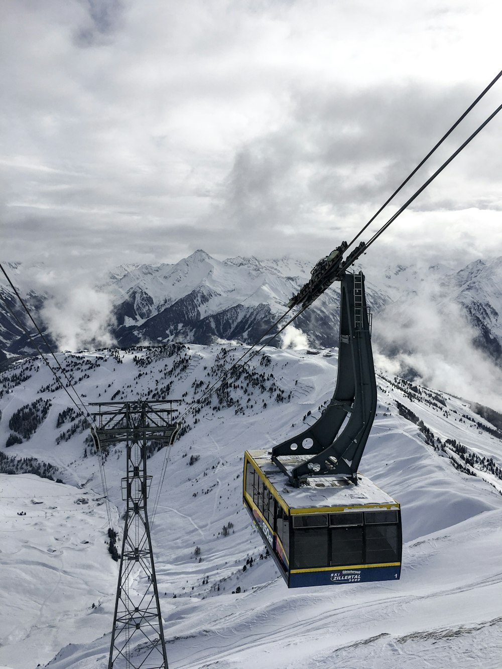 a ski lift going up a snowy mountain