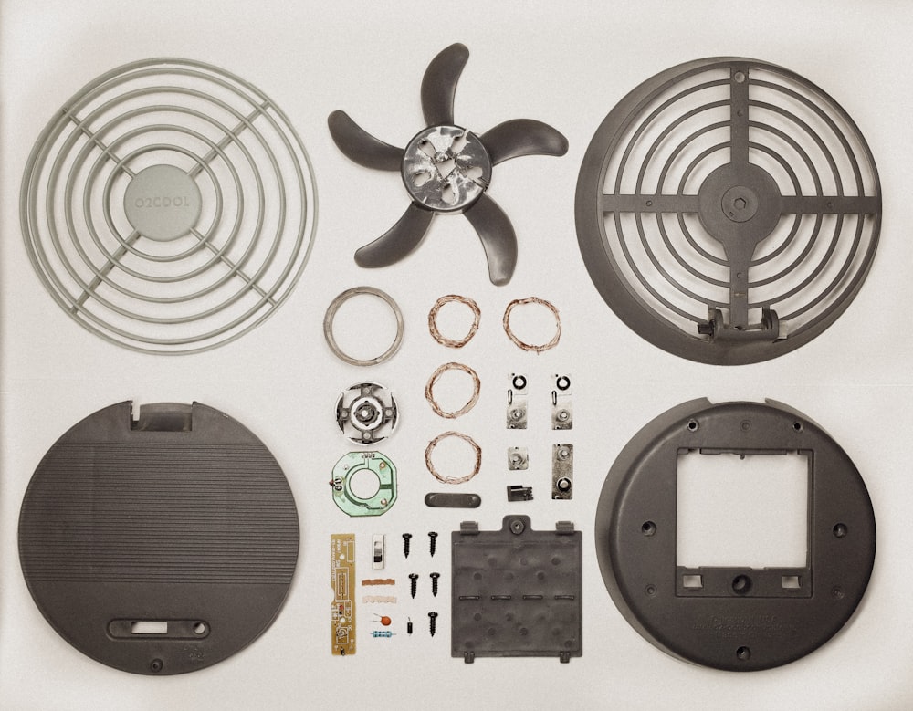 a picture of a fan, parts, and tools on a white background