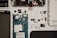 This image features a disassembled smartphone with various components laid out on a flat surface. Visible are the screen, battery, circuit board, camera module, and several smaller components such as screws and connectors. The arrangement is organized and methodical, displaying each part individually.