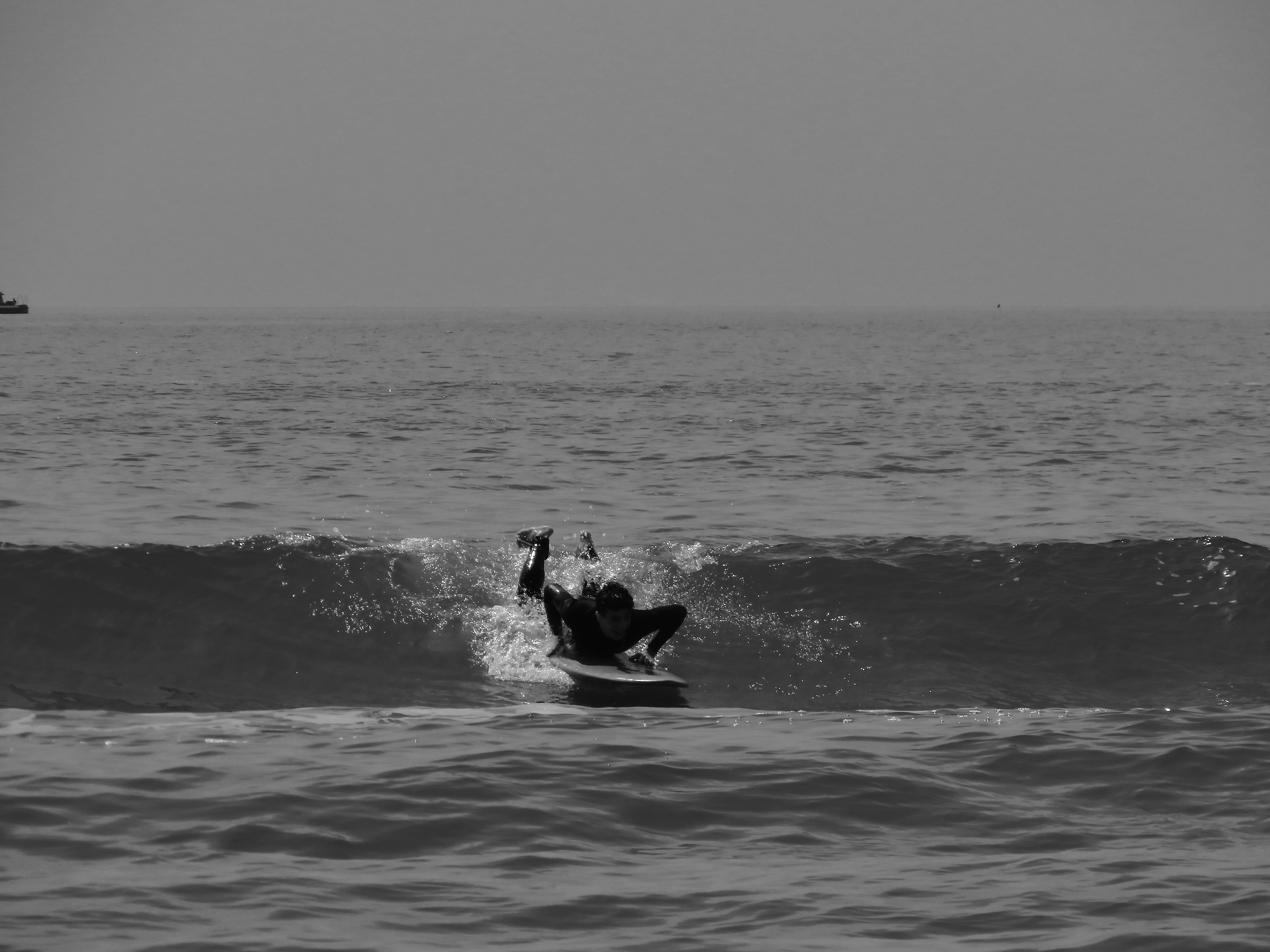 a man riding a wave on top of a surfboard
