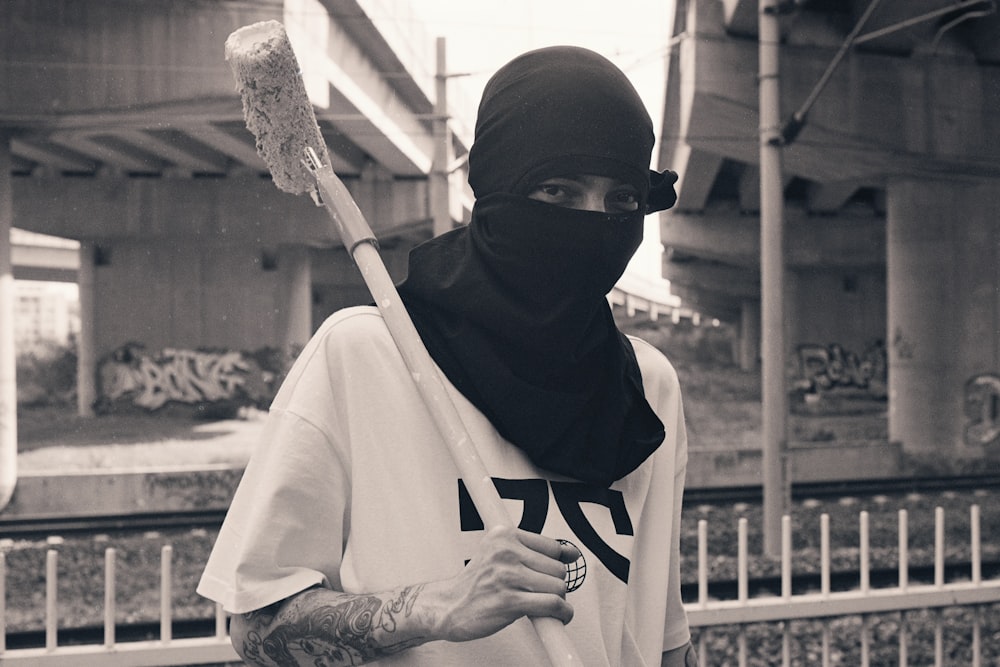 a man wearing a mask and holding a baseball bat