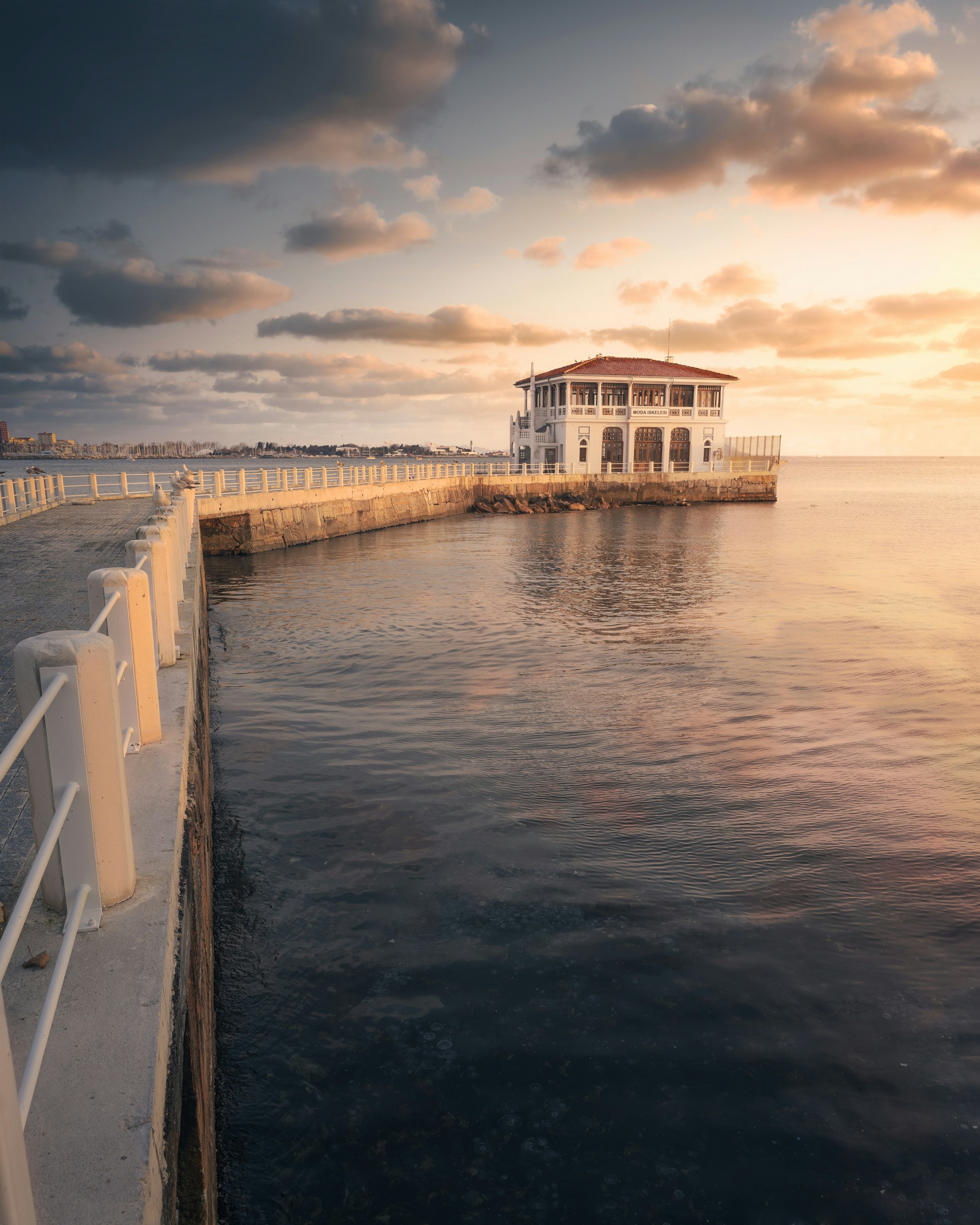 a house sitting on the edge of a body of water