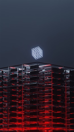a tall building with a neon cube on top of it