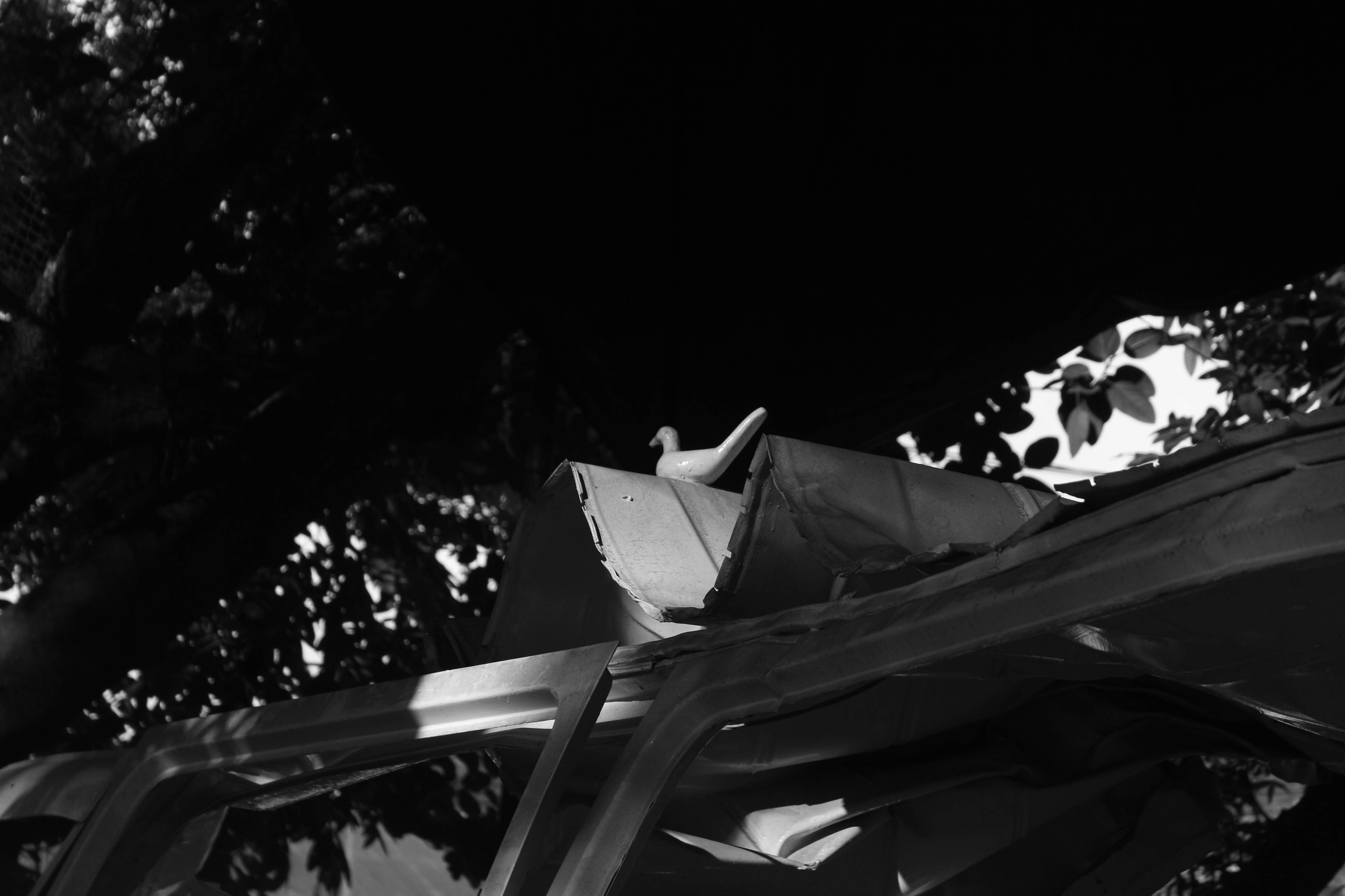 a black and white photo of a broken car