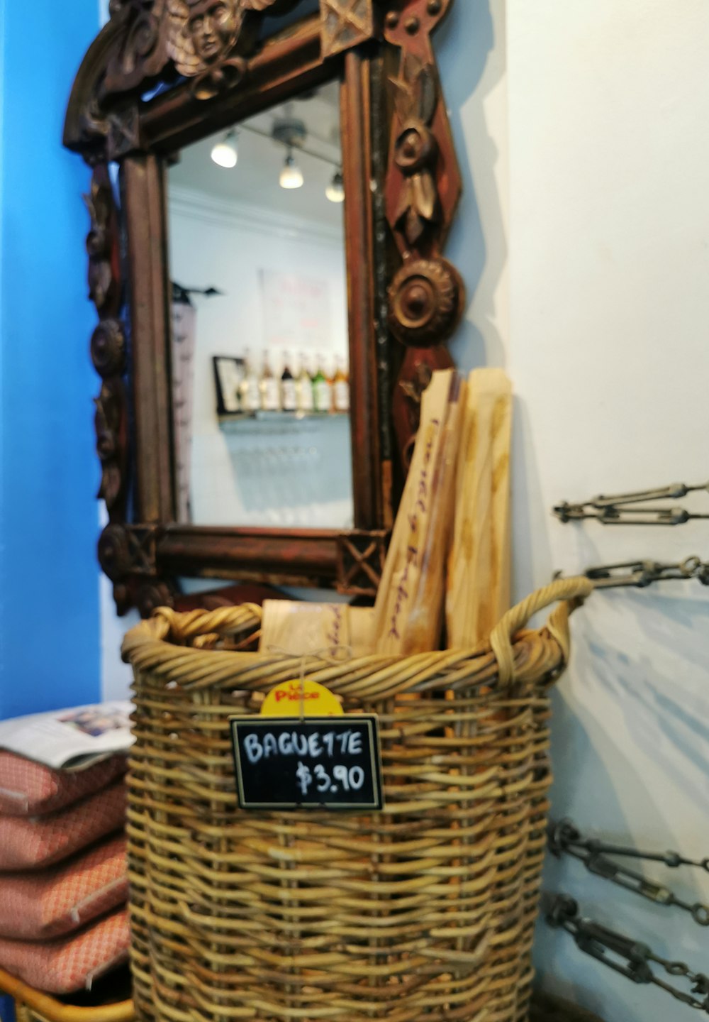 a basket with a sign on it sitting in front of a mirror