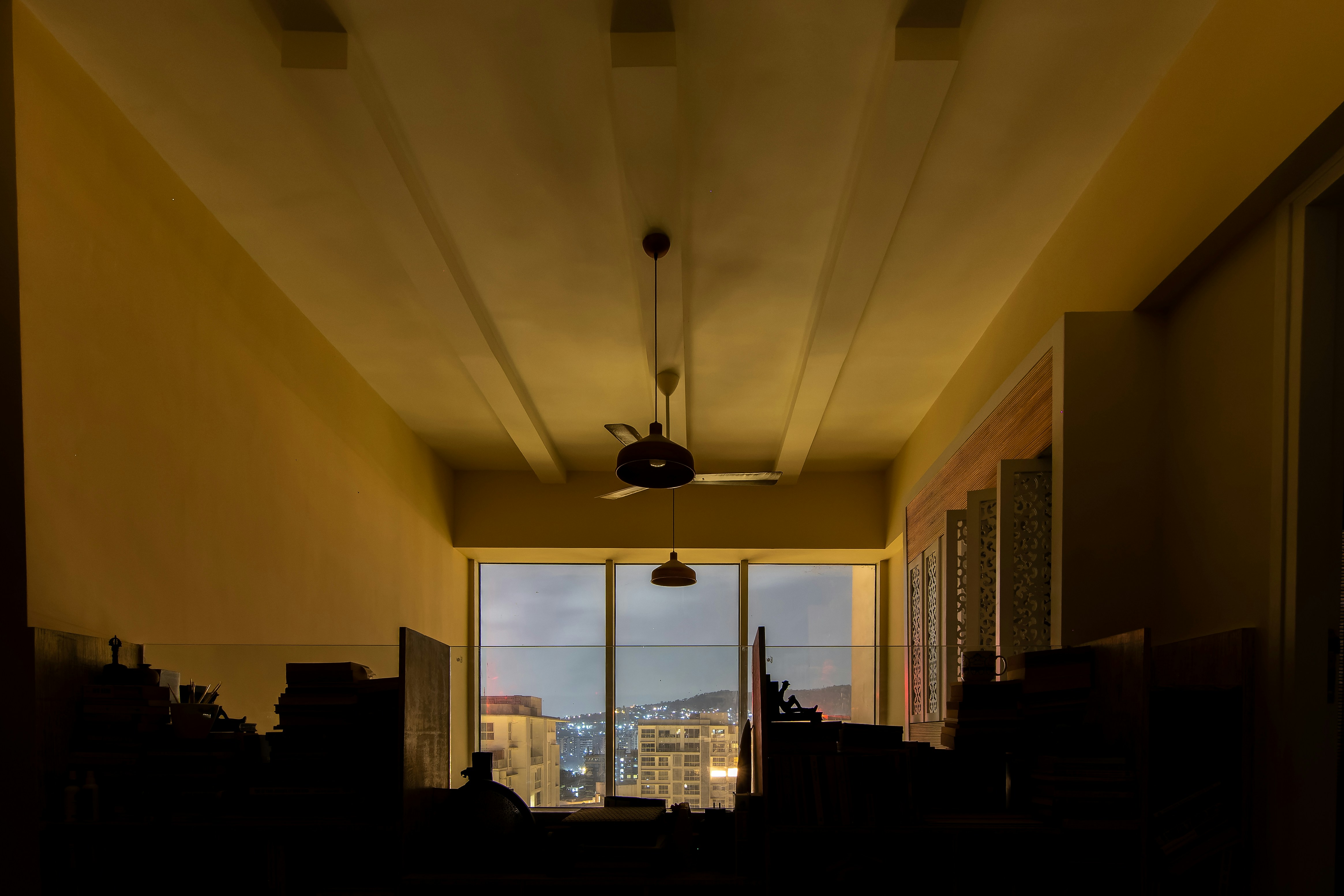 a room with a ceiling fan and a window