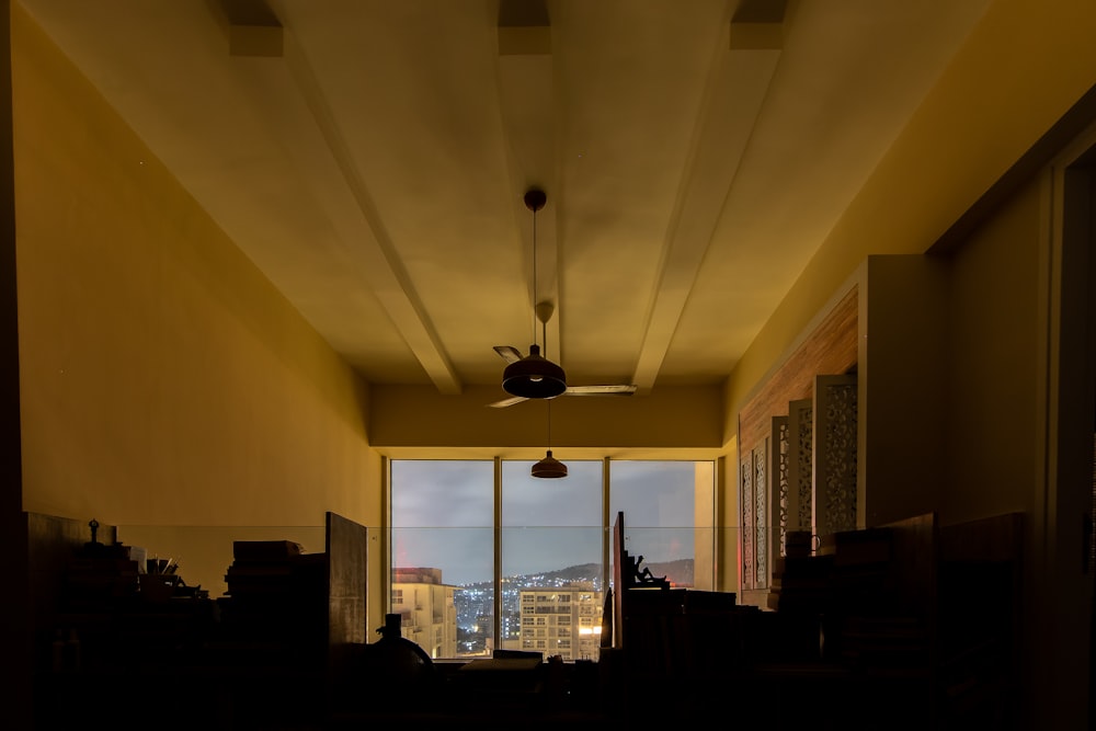 a room with a ceiling fan and a window