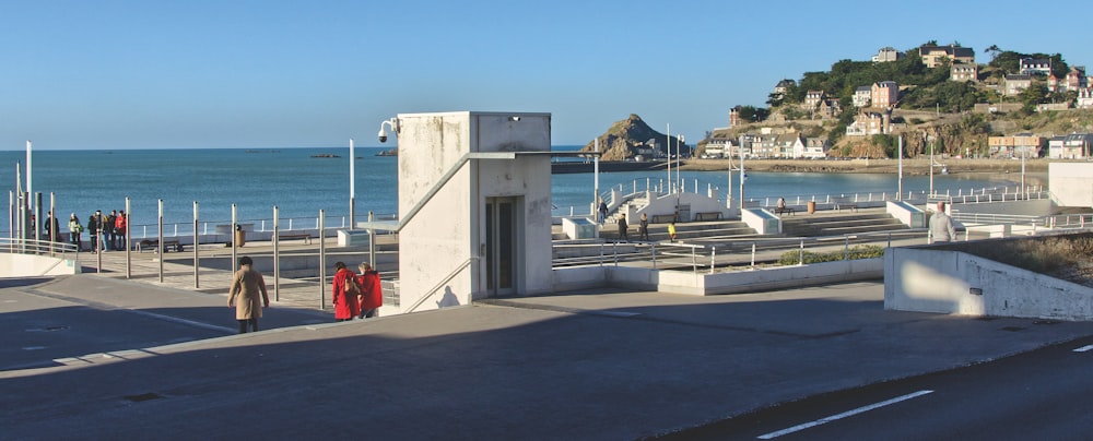 a couple of people that are standing on a pier