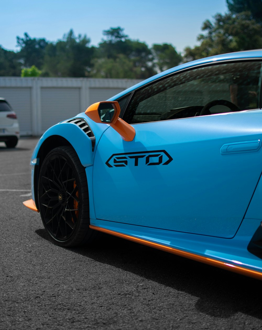 a blue sports car parked in a parking lot