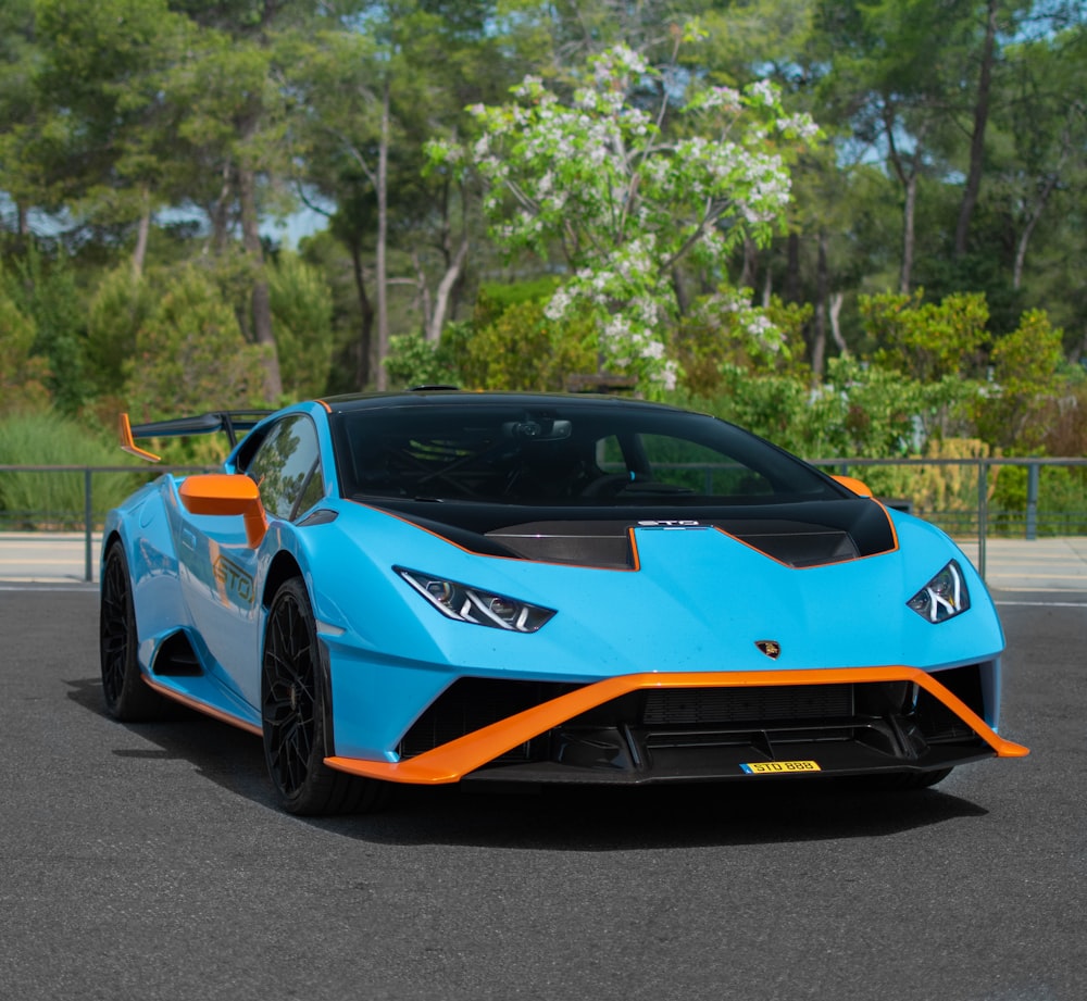 a blue and orange sports car parked in a parking lot