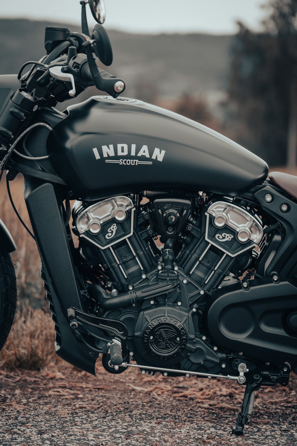 a black indian motorcycle parked on the side of a road