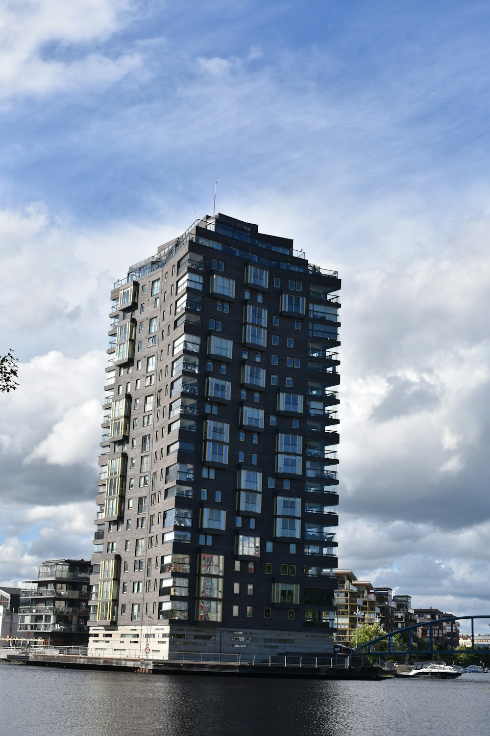 a tall building sitting next to a body of water