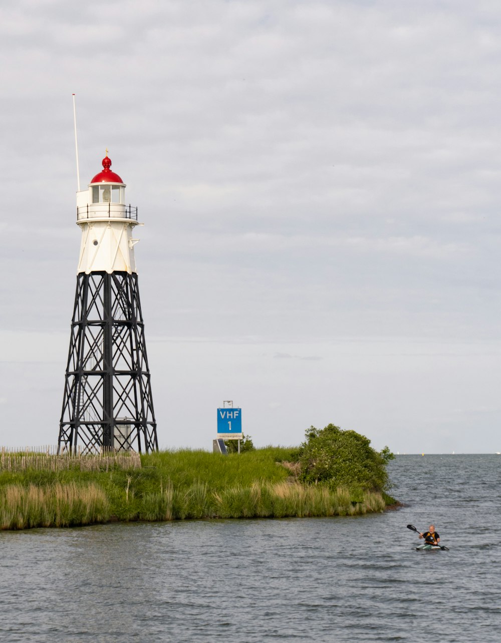 a light house sitting on top of a small island